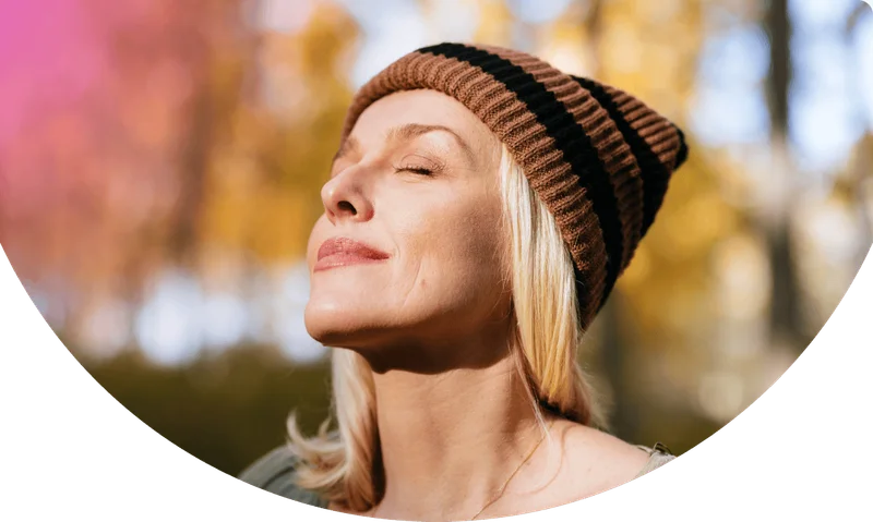 Portrait of a Woman Standing in the Woods Enjoying the Sunlight