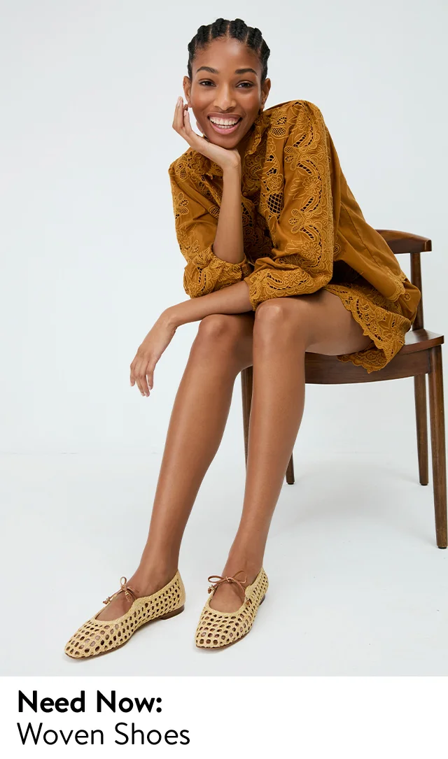 A woman wearing open-weave mary jane flats.