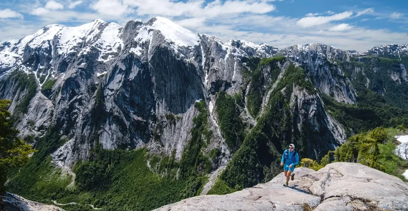 A person runs high above an alpine valley.