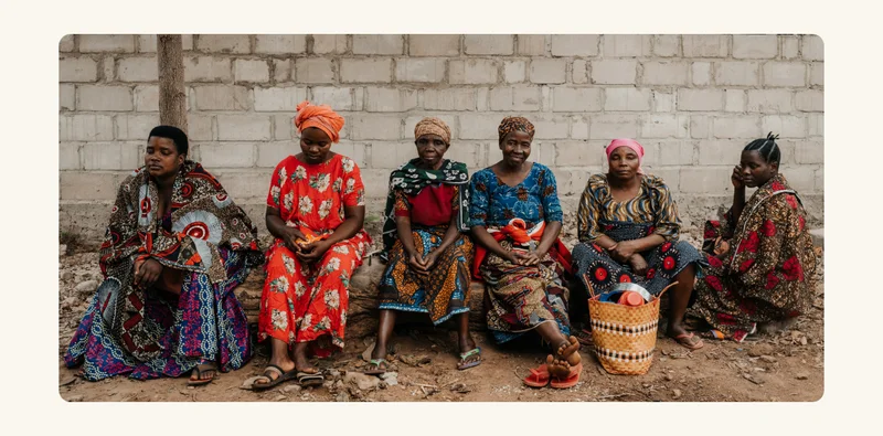 A group of women sitting together in a row.