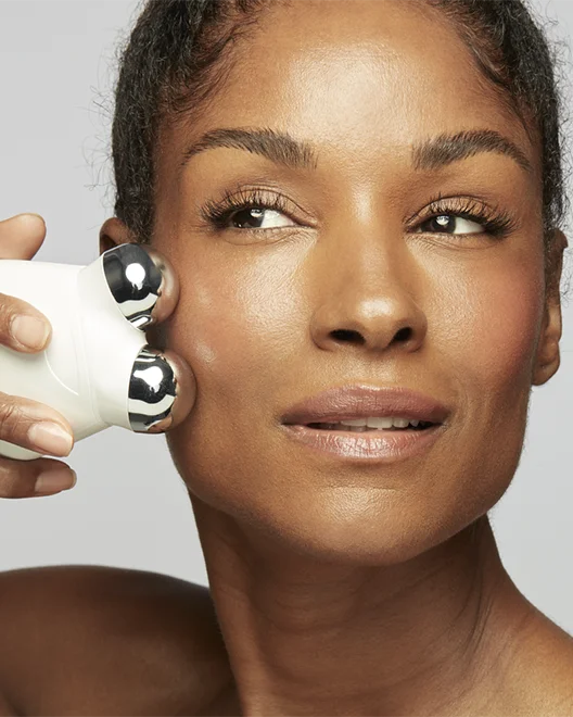 Woman targeting the cheek area using the Trinity Facial Trainer Attachment