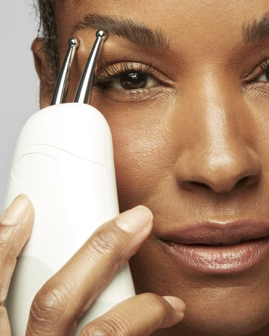 Woman using the Effective Lip & Eye Attachment around the eye area