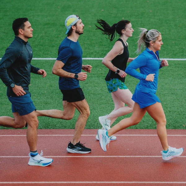 Group of people running on a track