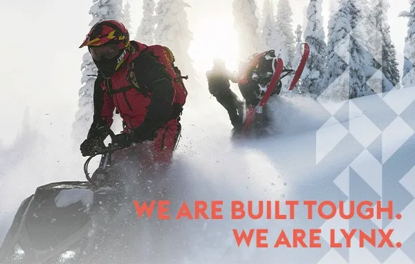 Lynx riders snowmobile in deep snow