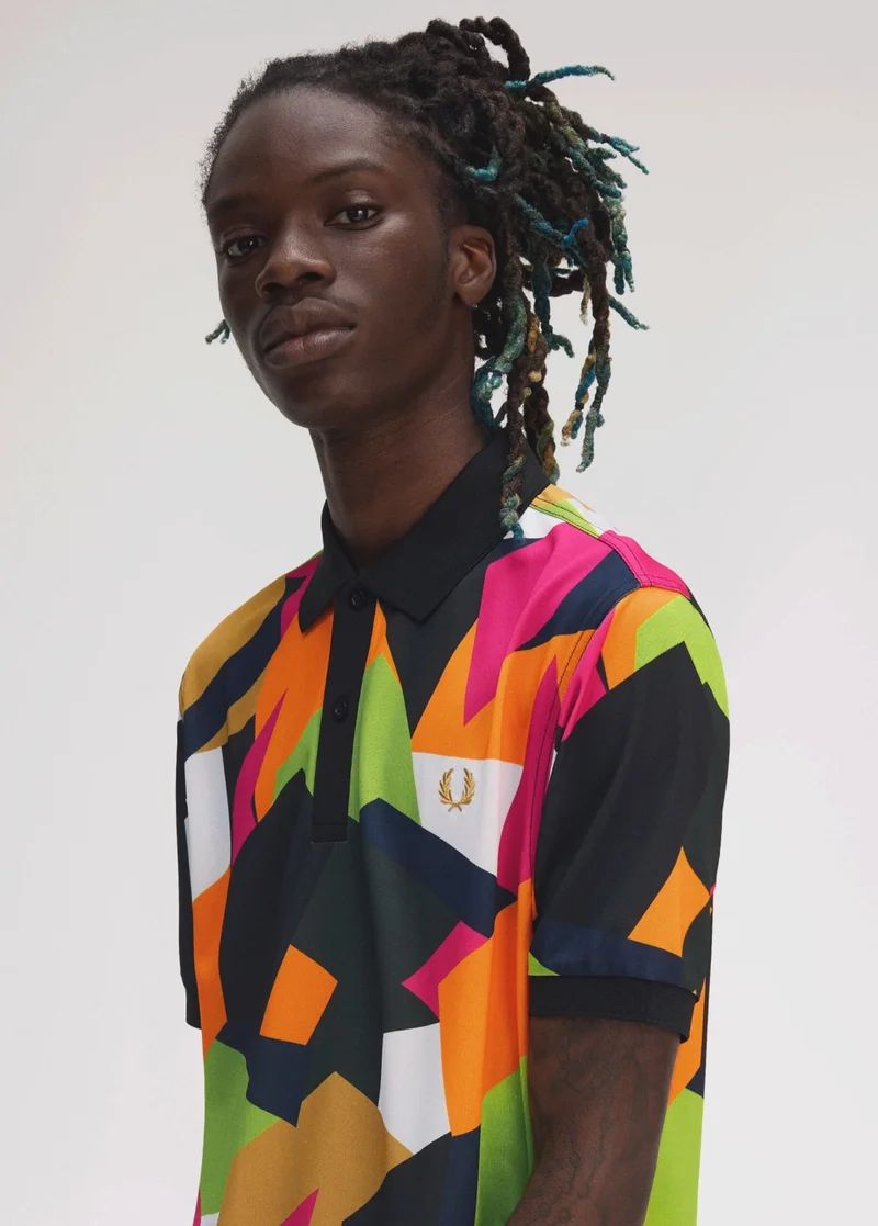 Fred Perry New Releases: model wears a printed Fred Perry Tennis Shirt