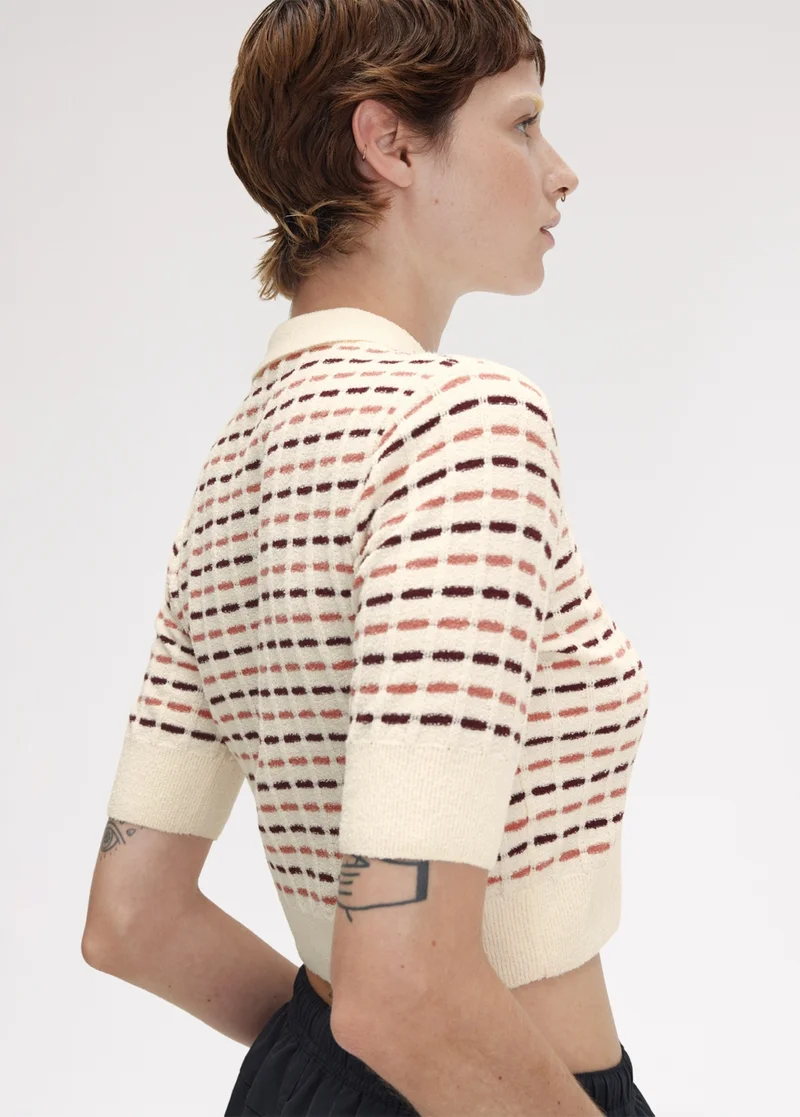 White female model wears a Fred Perry Boucle Knitted Polo Shirt