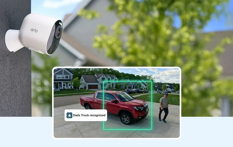Arlo security camera mounted on the exterior of a home. Simulated point of view image shows a vehicle in the front driveway. User interface element reads: Dads Truck recognized.