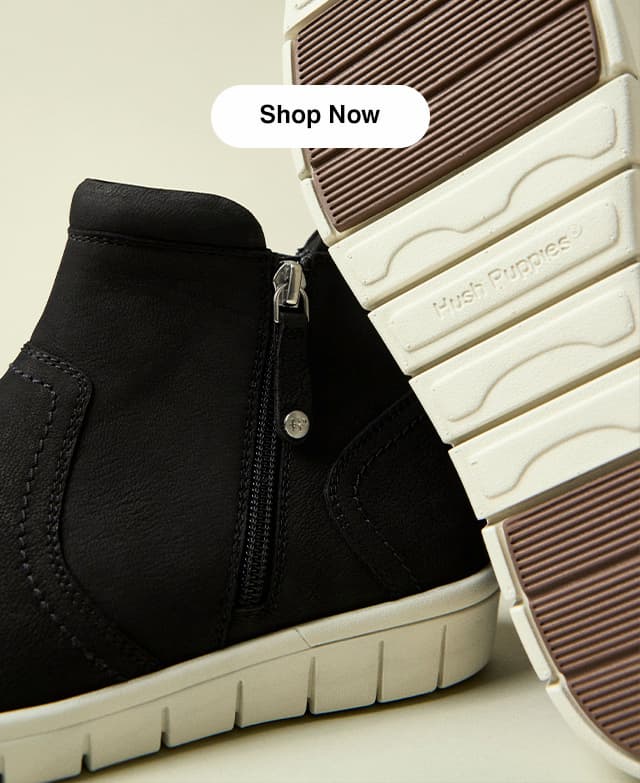 Another image of the leather ankle bootie revealing the zipper on one shoe and the sole on the other. Shop Now.