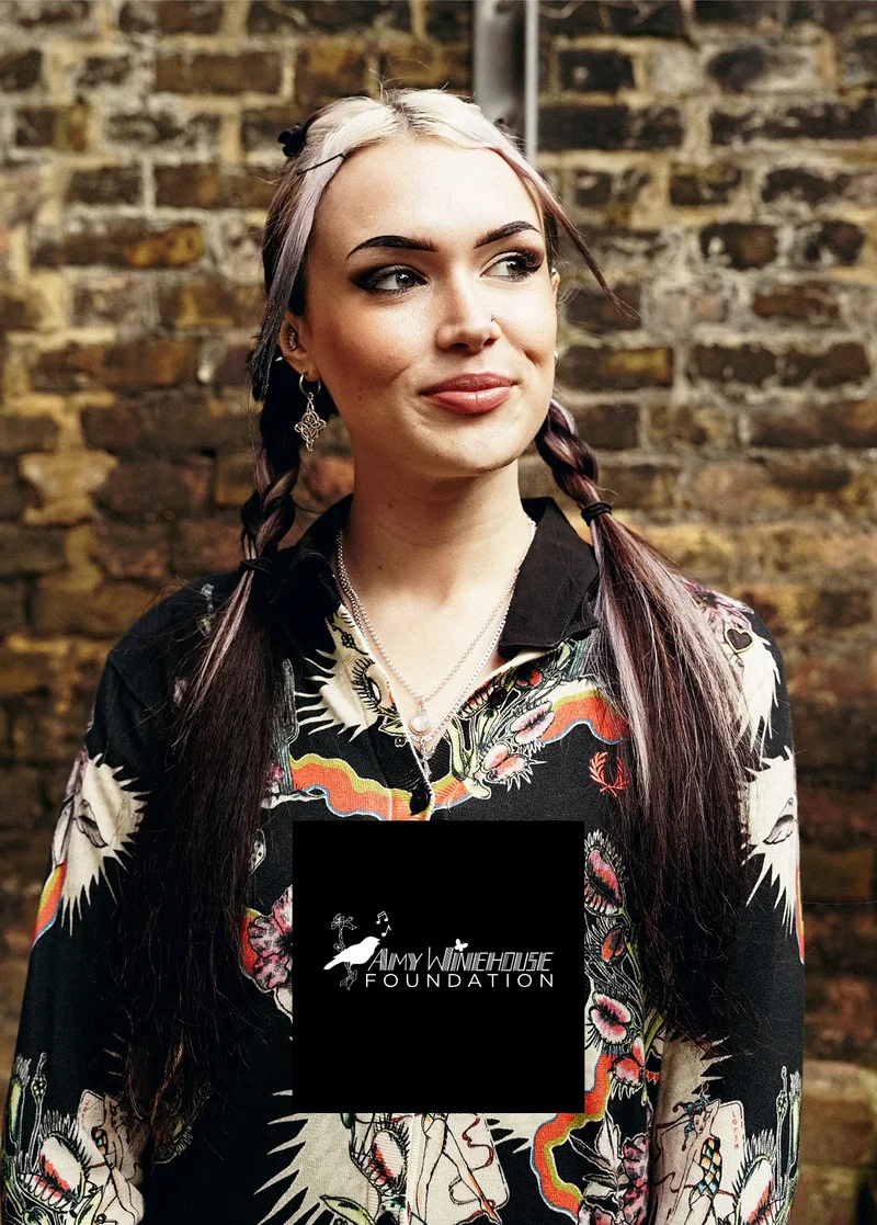 Amy Winehouse Foundation: Female wearing a Fred Perry x Amy Winehouse Foundation Printed Cardigan