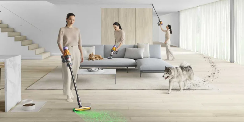 A woman using a Dyson vacuum around a living room