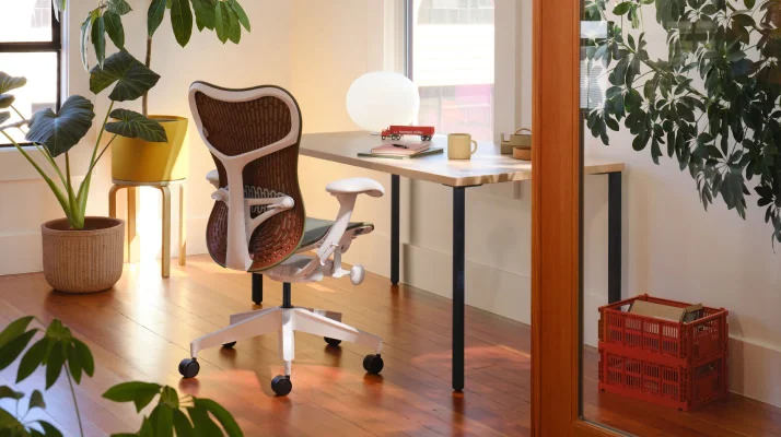 Mirra 2 Chair in Olive, Cordovan and Alpine at a desk in a home office environment surrounded by plants.