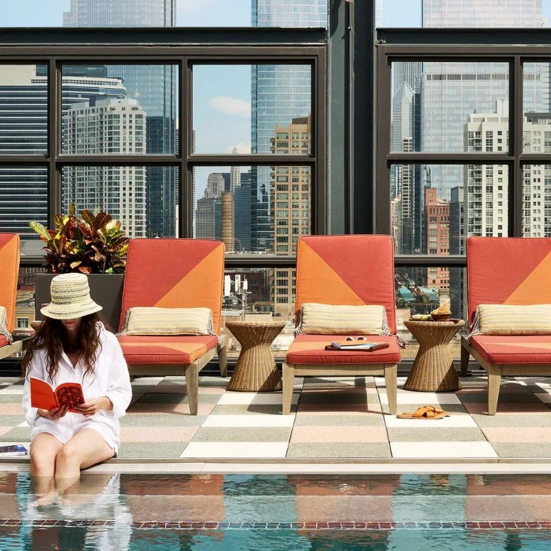 Woman reading by the pool