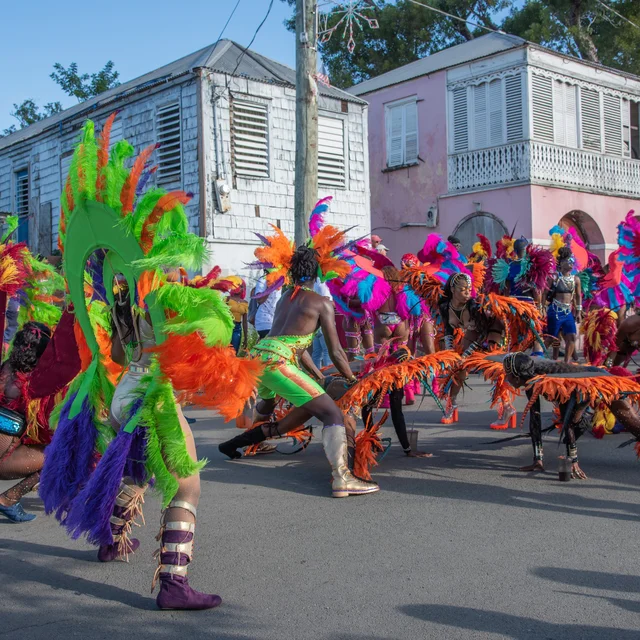 Performers dancing in feathered costumes at the adult parade in downtown Frederiksted in the US VI