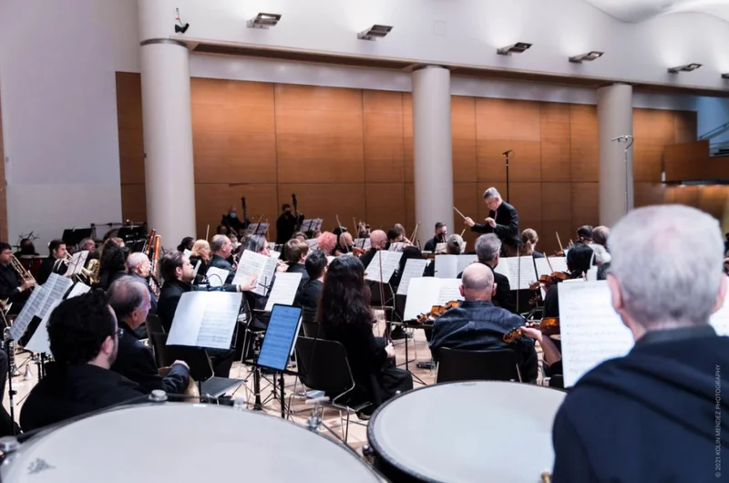 An orchestra being led by a conductor
