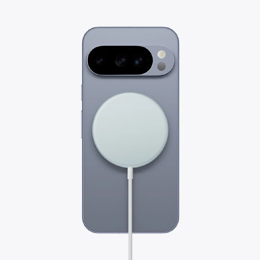 A shot of the back of a Google Pixel smartphone with a circular, light blue wireless charging pad magnetically attached to its center.