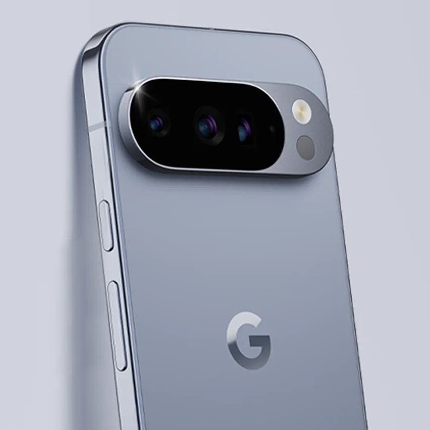 A close-up shot of the back of a light blue Google Pixel smartphone, highlighting the chrome camera bar with three lenses and a flash. The Google G logo is centered on the back.