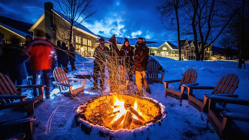 Image description: Friends gathered around the fire pit at Emerson Resort & Spa in the Catskills