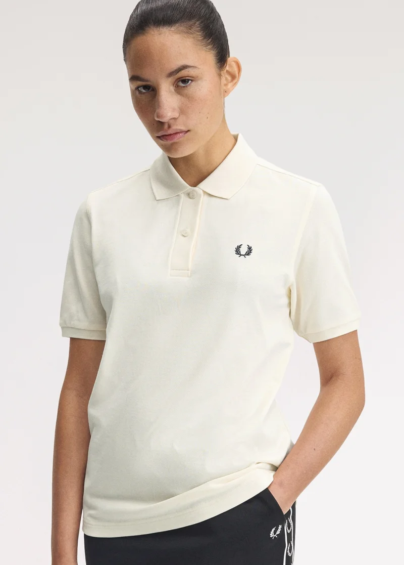 A female model wears a one-colour Fred Perry polo in ecru