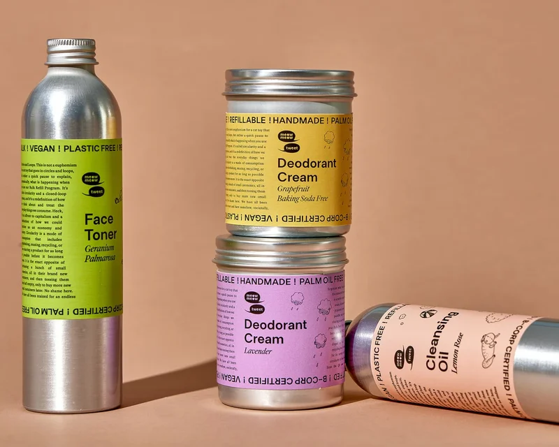 Silver bottles with colorful labels sit against a brown background