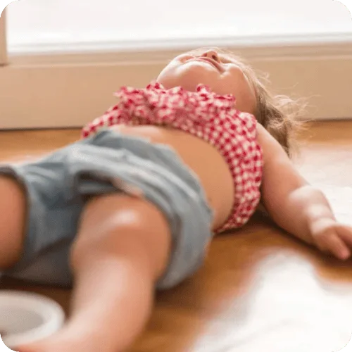 a toddler lying on the floor having a tantrum