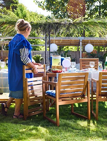 Woman setting up outdoor IKEA furniture
