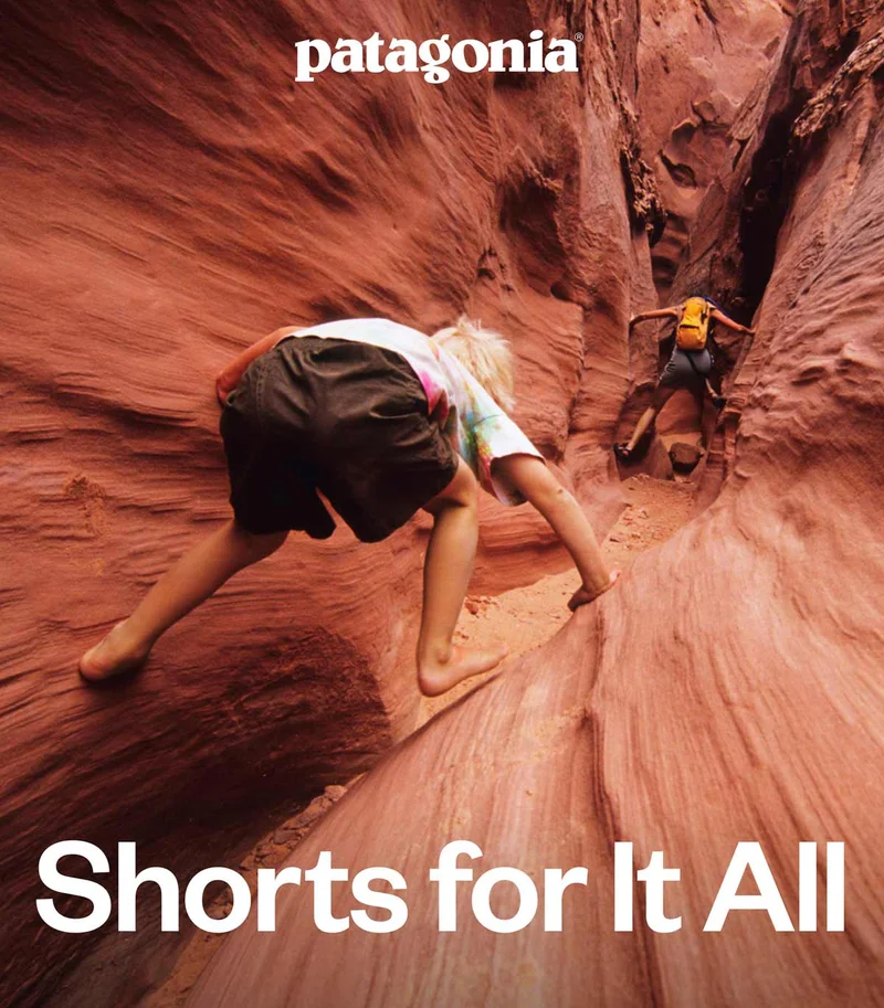 Patagonia. Shorts for It All. Two people hike through a slot canyon.