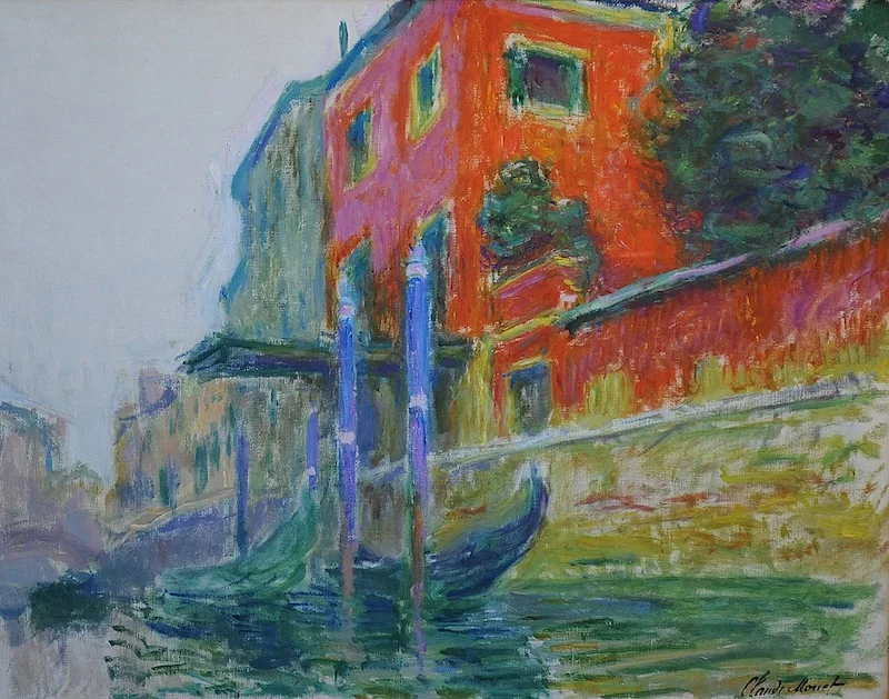 An Impressionist painting of a canal with boats and a red building in the background