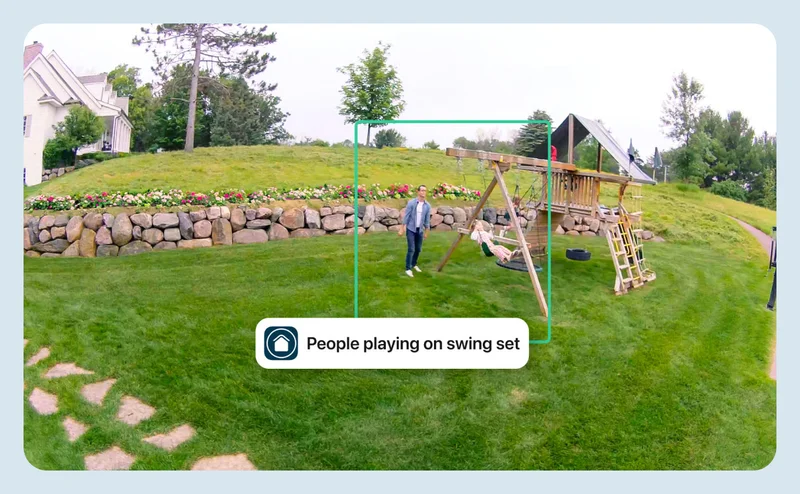 Simulated point of view image depicting a parent and child playing on a swing set in the backyard. A green box highlights the people to indicate an event with a simulated event caption that says: People playing on swing set.