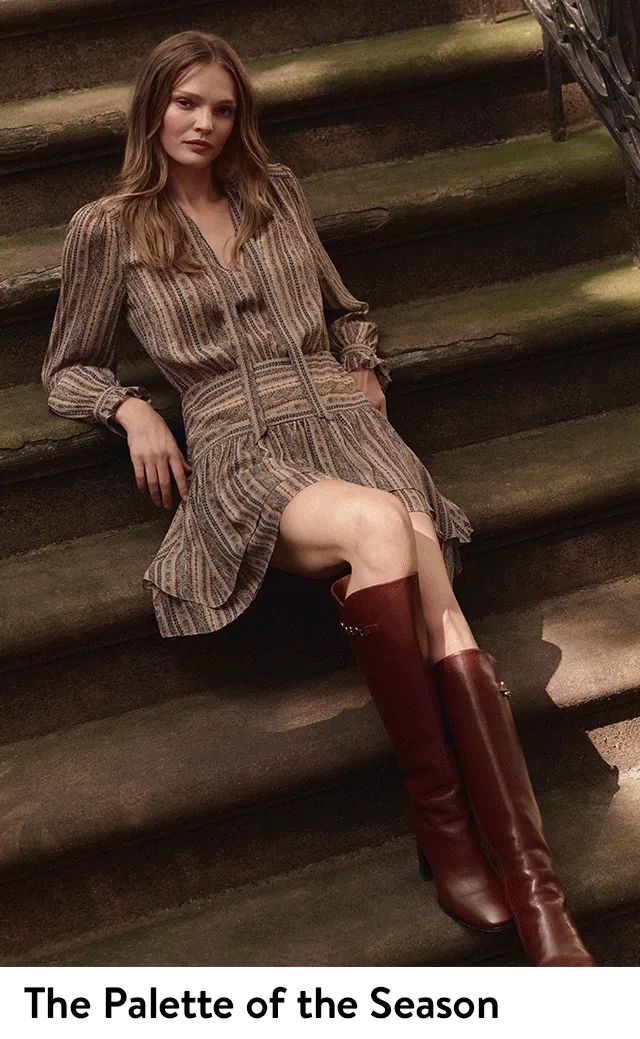 A woman wearing a black top with a matching houndstooth blazer and miniskirt; a woman wearing a patterned dress and knee-high boots.