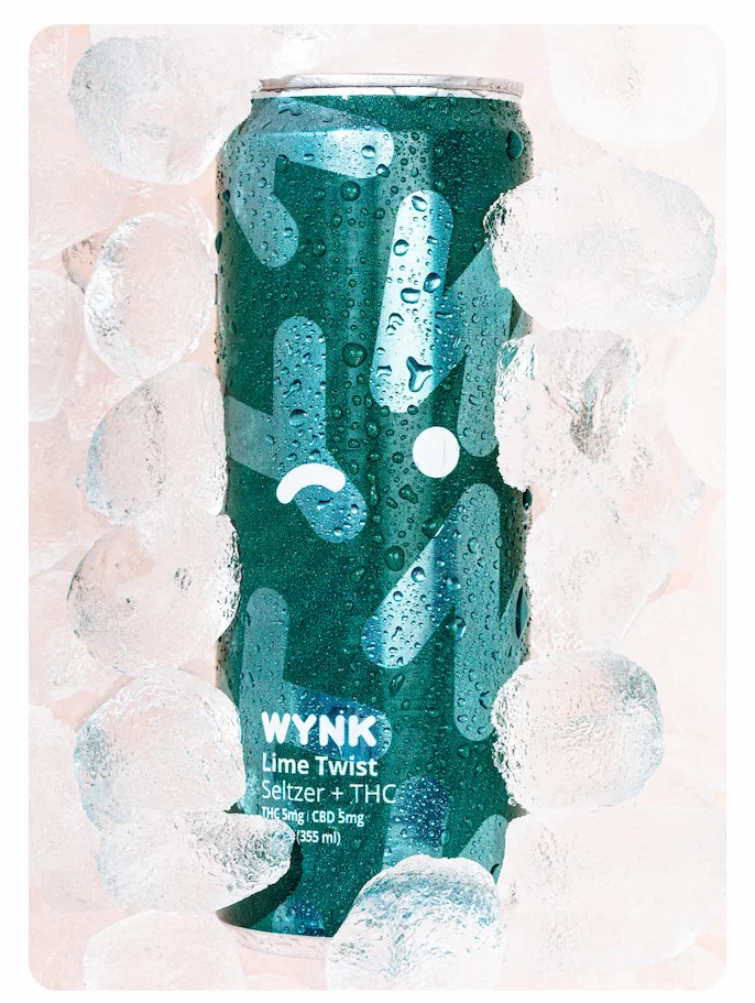 Photo of a cold can of Lime Twist Wynk in a bed of ice cubes.