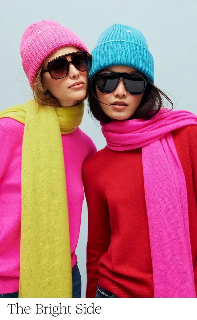 Two women in colorful beanies and scarves.