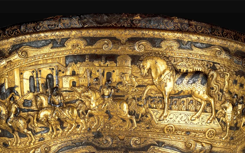 This magnificent 16th-century saddle shows the Trojans bringing the wooden horse into their city, unaware of the Greek enemies hidden inside.