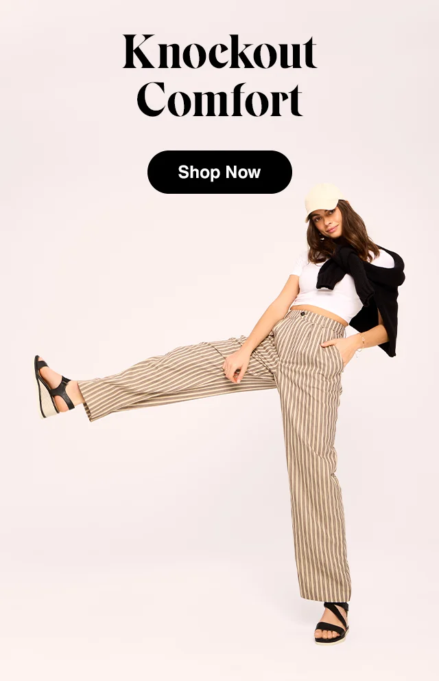 A woman wearing a baseball cap, cropped tee, tied cardigan, striped pants and the Inca wedge in black. Shop Now.