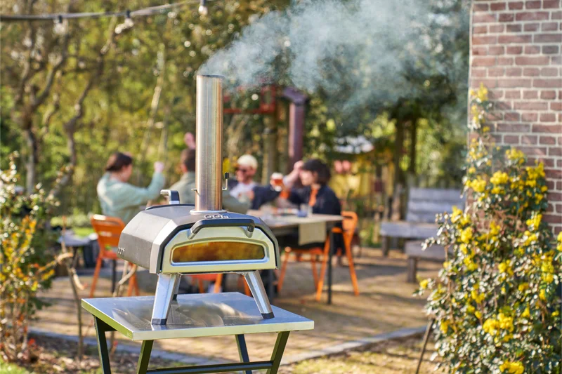 Karu 2 in the foreground with a group enjoying food and drinks in the back
