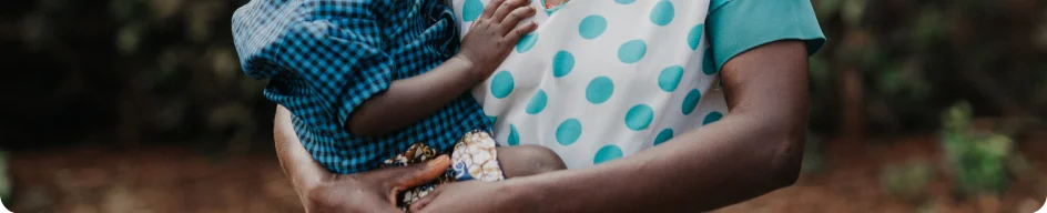 Photo of a woman holding her son in Tanzania