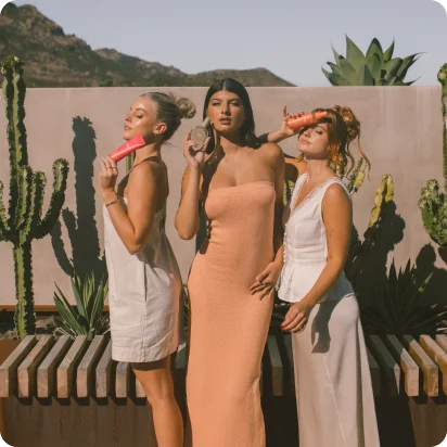 An image of women holding dae's hair products