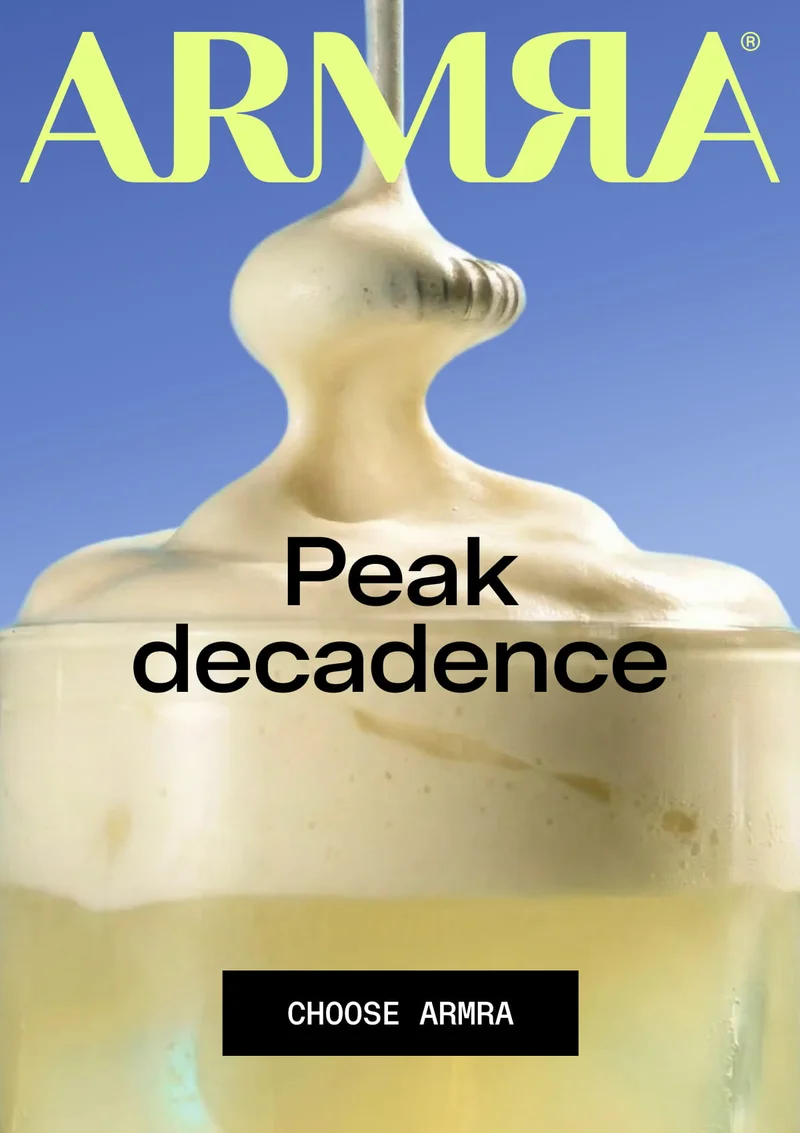 ARMRA Cream Top — “Peak decadence.” Close-up of thick cream pouring into a glass. Choose ARMRA.