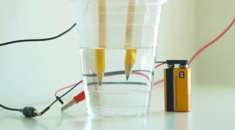 Use pencils to create an electric circuit to separate the hydrogen from the oxygen in water.