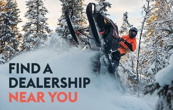 People riding Lynx sleds in the snow