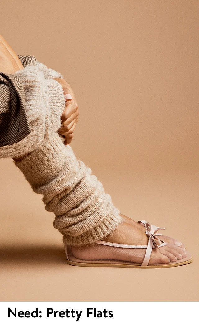Woman wearing metallic ballet flats from Free People.