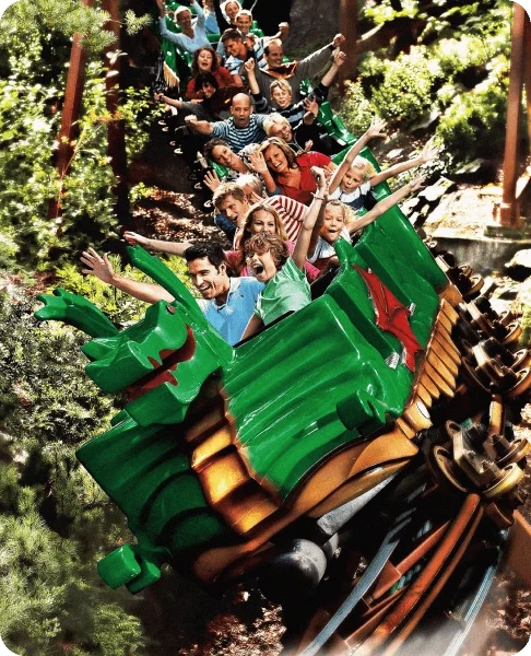 Image Description: Kids and adults having fun on a roller coaster at LEGOLAND Billund Resort in Denmark