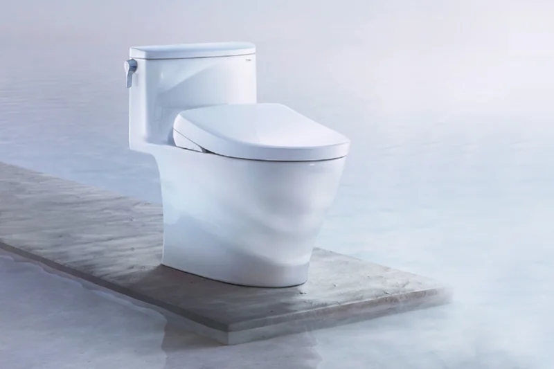 A TOTO S7A WASHLET+ displayed on a wooden platform over cool blue water
