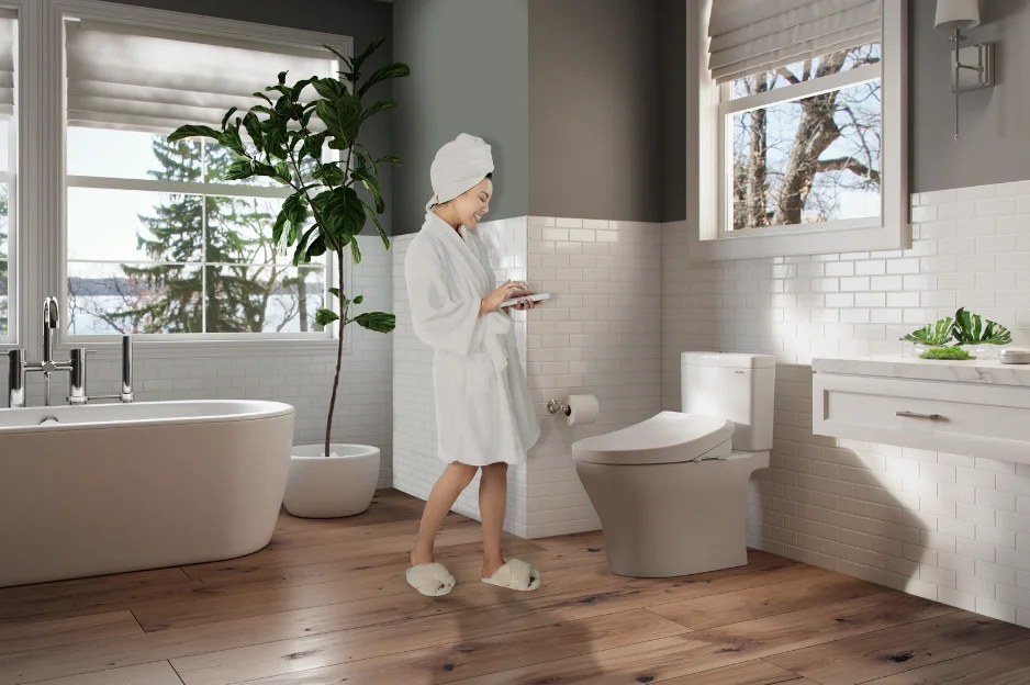 A TOTO K300 WASHLET+ in a sunlit bathroom decorated with green plant life