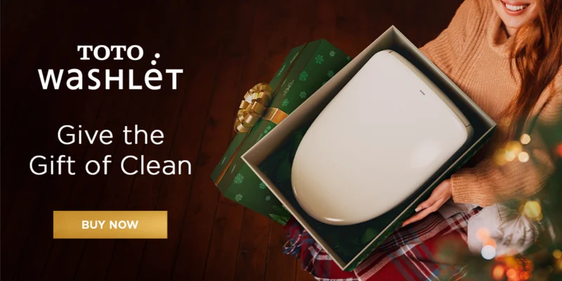 A woman opens a holiday gift to find a TOTO WASHLET inside