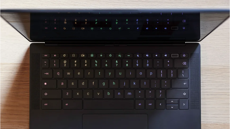 Photo of a black Chromebook sitting on a table. It’s open, revealing its keyboard.