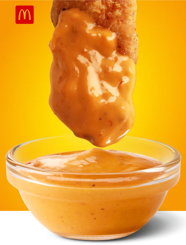 McCrispy Strip dipped in sauce.