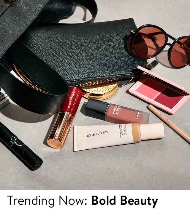 An array of makeup products; two models with colorful eye makeup.