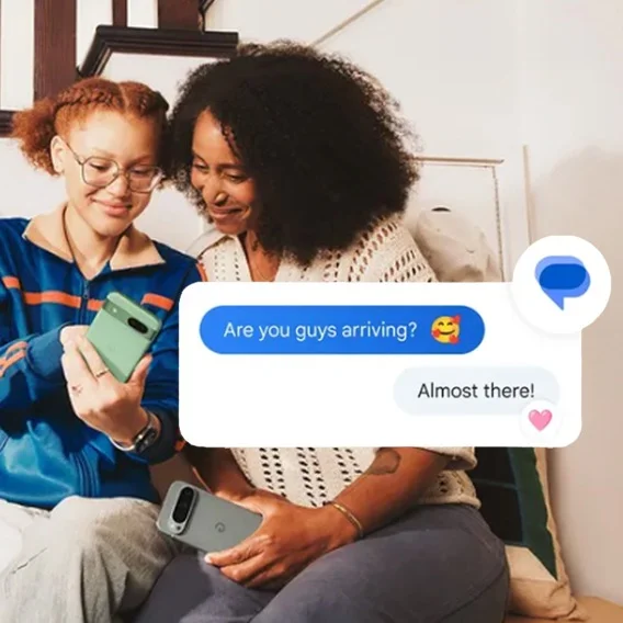 two people sit side by side looking at a smartphone with the superimposed illustrated text box reading “Are you guys arriving”