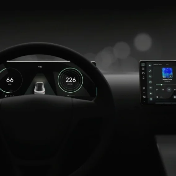 image of a steering wheel in a car with multiple dashboard screens