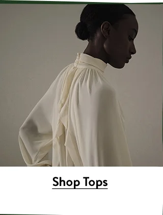 A woman wearing a diaphanous blouse.